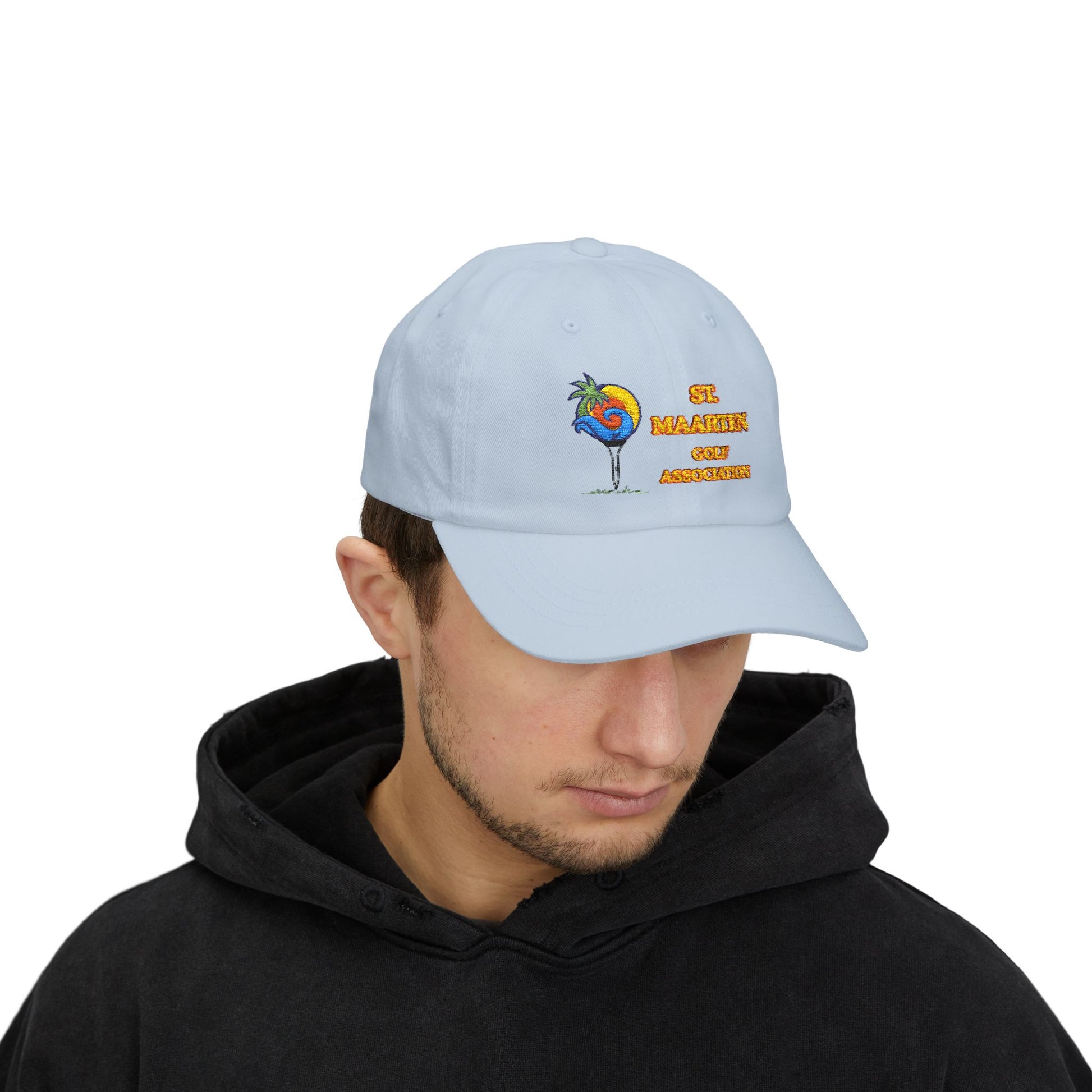 Person wearing a light blue cap with a colorful design and text on a white background