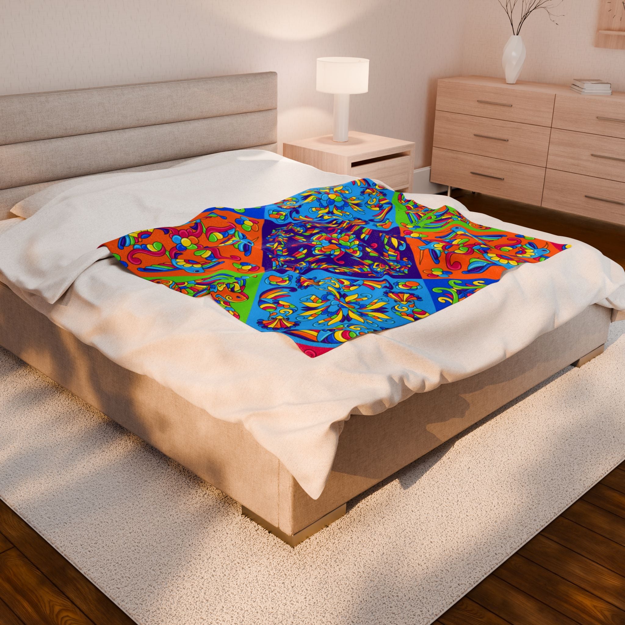 Psychedelic floral mandala blanket in bright blue and orange tones