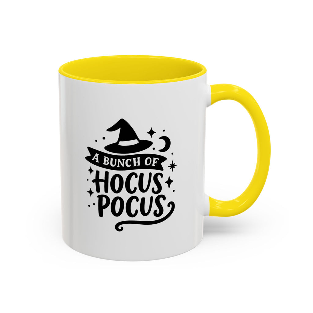 White two-tone coffee mug with a yellow handle and interior and a black 'A Bunch of Hocus Pocus' witch-hat design, on a white background
