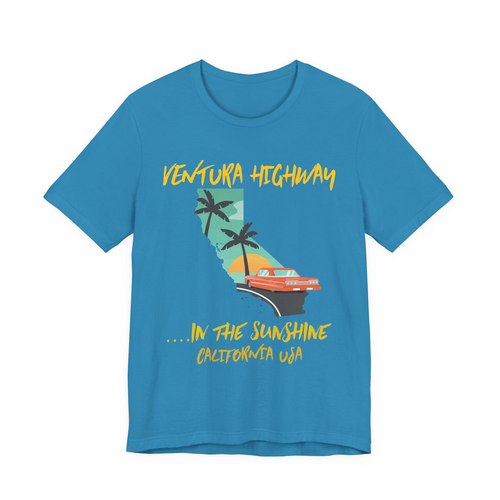 Turquoise t-shirt with a 'Ventura Highway in the Sunshine, California USA' graphic featuring the California map, palm trees, and a red convertible, on a white background