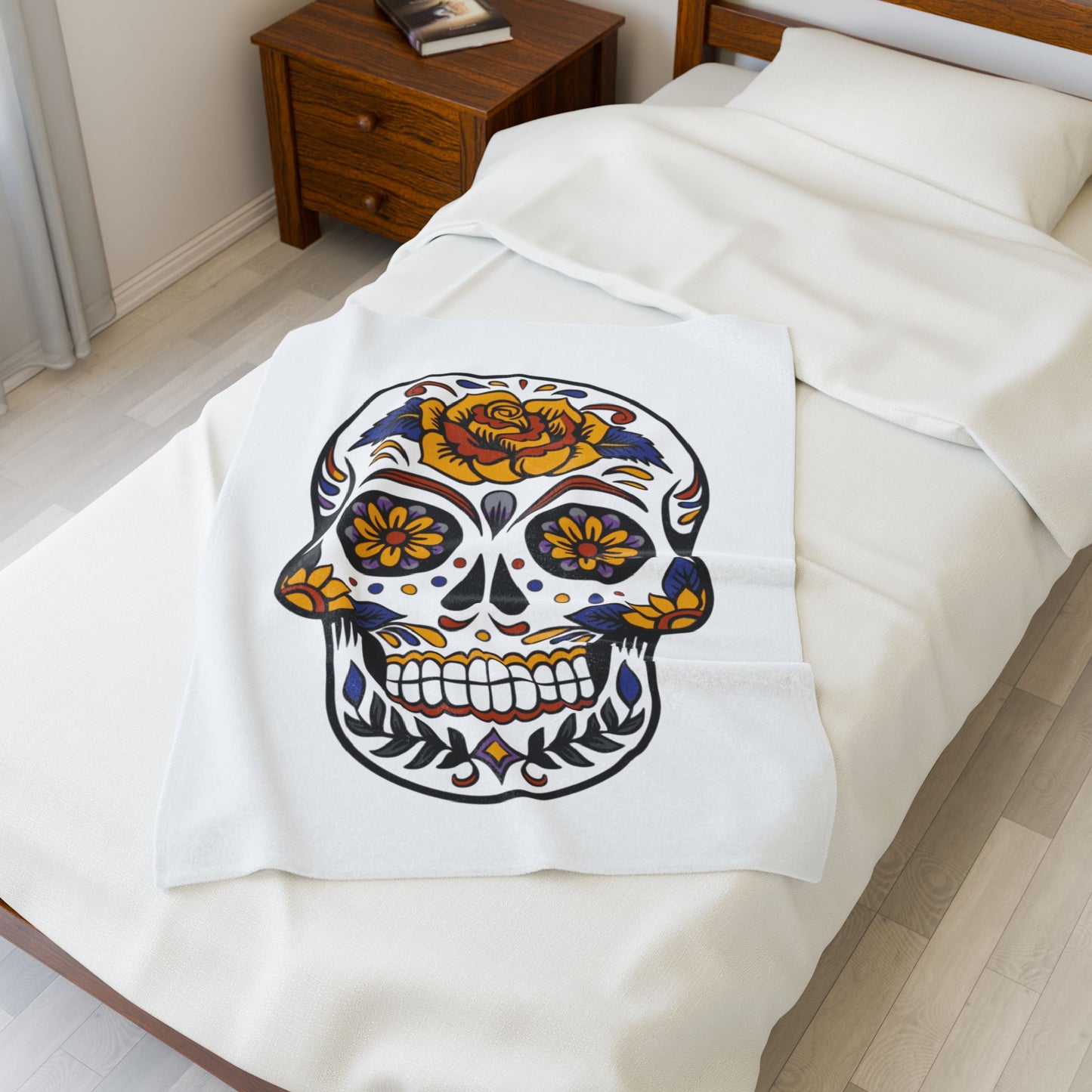 Sugar skull blanket on a bed in a bedroom.