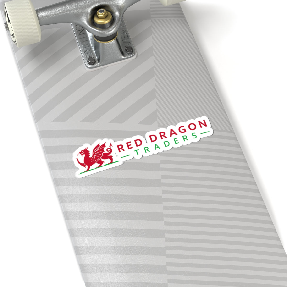Skateboard with a 'Red Dragon Traders' sticker on a white background