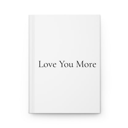 Journal with "Love You More" written on the white cover