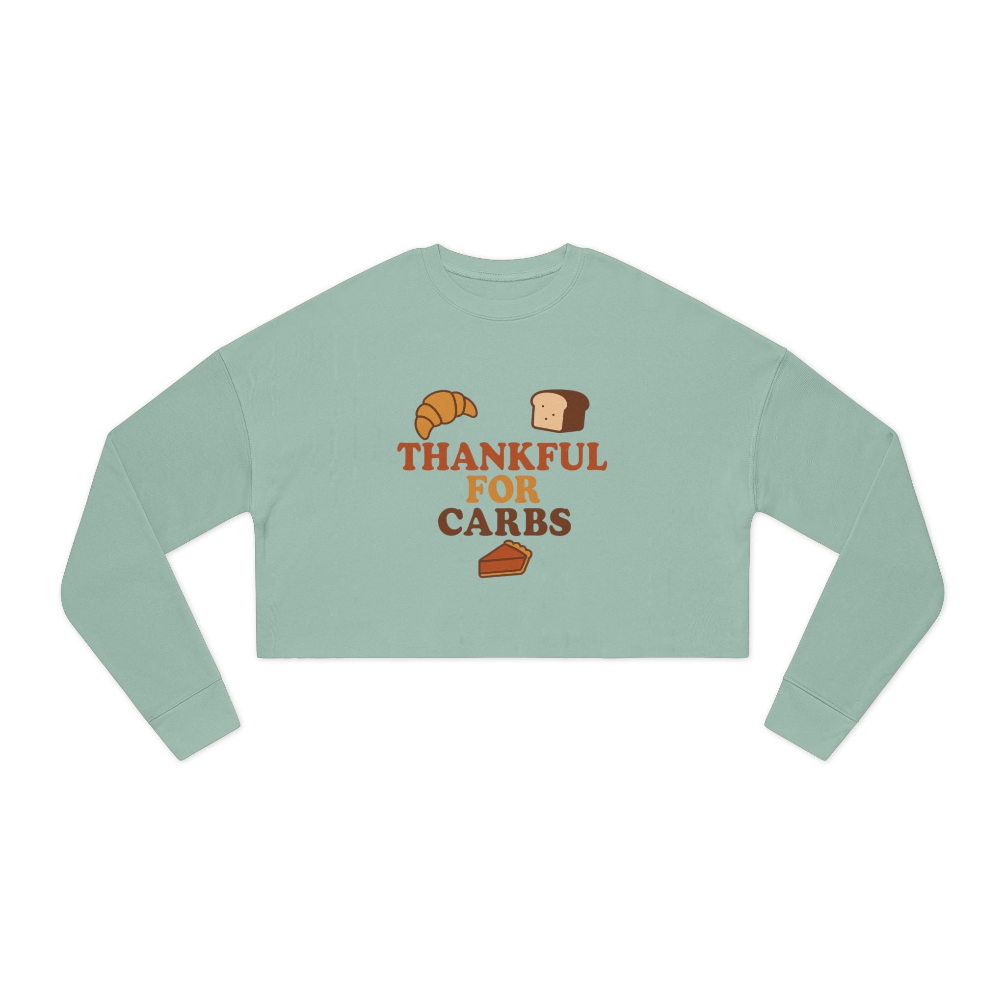 Light green long-sleeve crop top with 'Thankful for Carbs' text and graphics on a white background