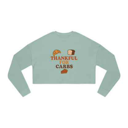 Light green long-sleeve crop top with 'Thankful for Carbs' text and graphics on a white background