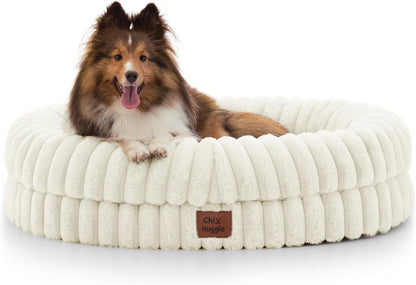 Dog lying on a fluffy white pet bed with a visible brand label.