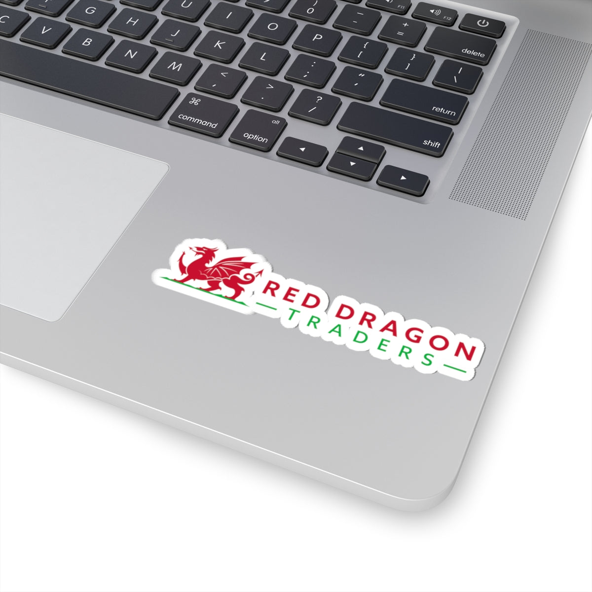 Laptop with a 'Red Dragon Traders' sticker on the palm rest area