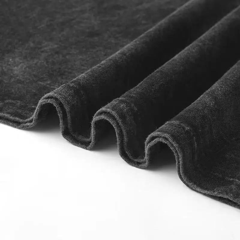 Close-up of dark gray fabric with a textured surface on a white background