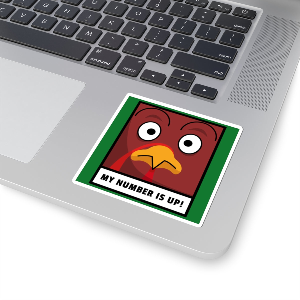 Laptop with a sticker of a cartoon turkey and text 'My number is up!' on the palm rest area.
