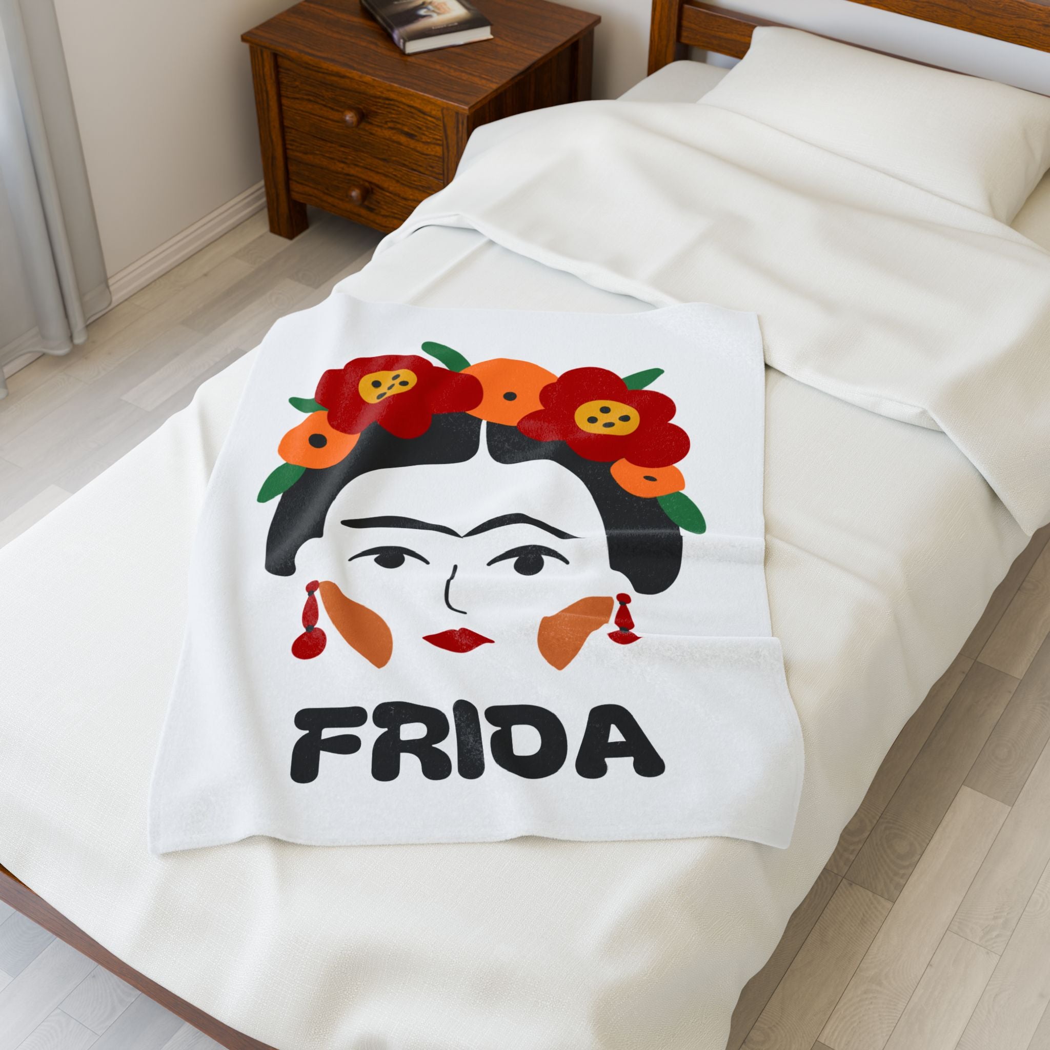 "Frida" Blanket in a small size overlaying bed 