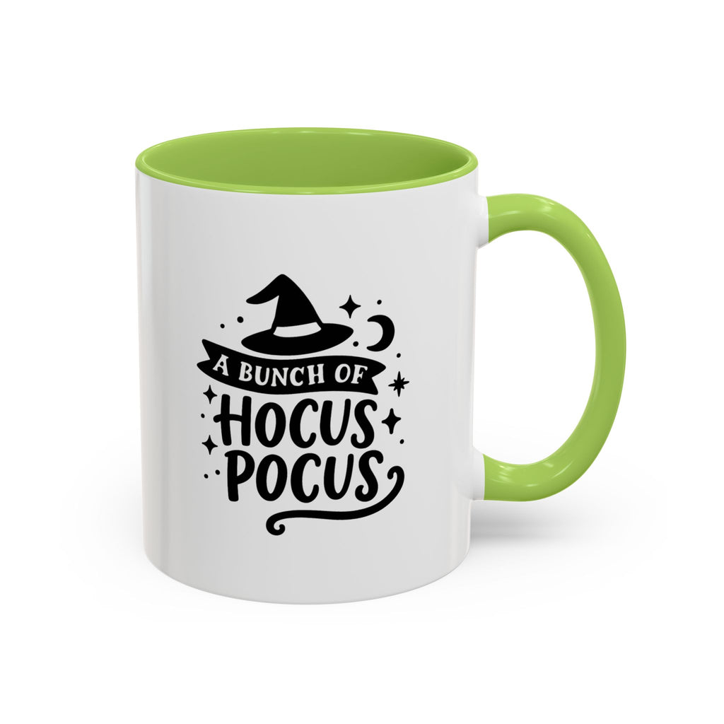 White two-tone coffee mug with a light green handle and interior and a black 'A Bunch of Hocus Pocus' witch-hat design, on a white background