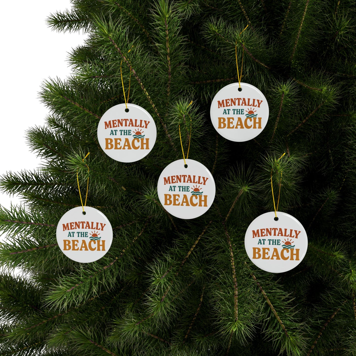 Ornaments with 'Mentally at the Beach' text hanging on a Christmas tree.