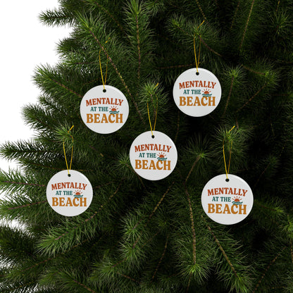 Ornaments with 'Mentally at the Beach' text hanging on a Christmas tree.