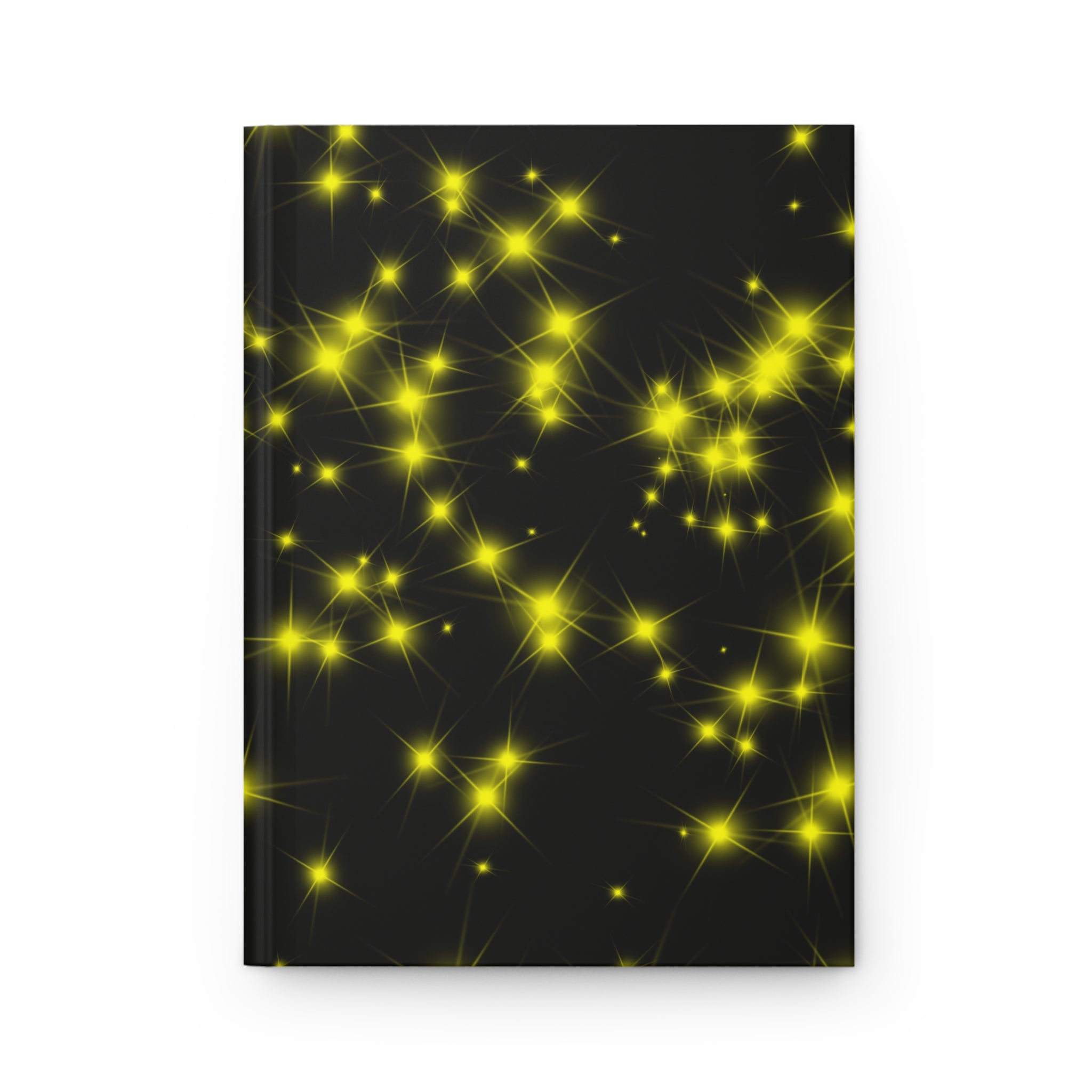 Black hardcover journal with a pattern of glowing yellow stars, on a white background.
