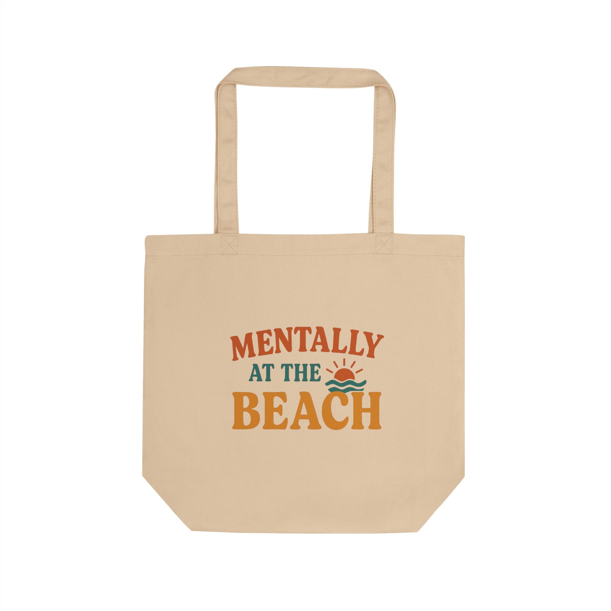 Beige tote bag with 'Mentally at the Beach' text and graphics on a white background