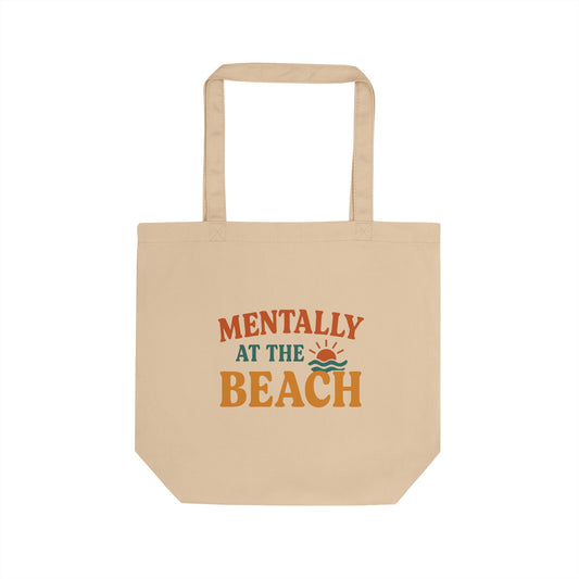 Beige tote bag with 'Mentally at the Beach' text and graphics on a white background