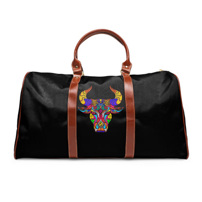 Black duffel bag with a colorful bull head design and brown handles on a white background