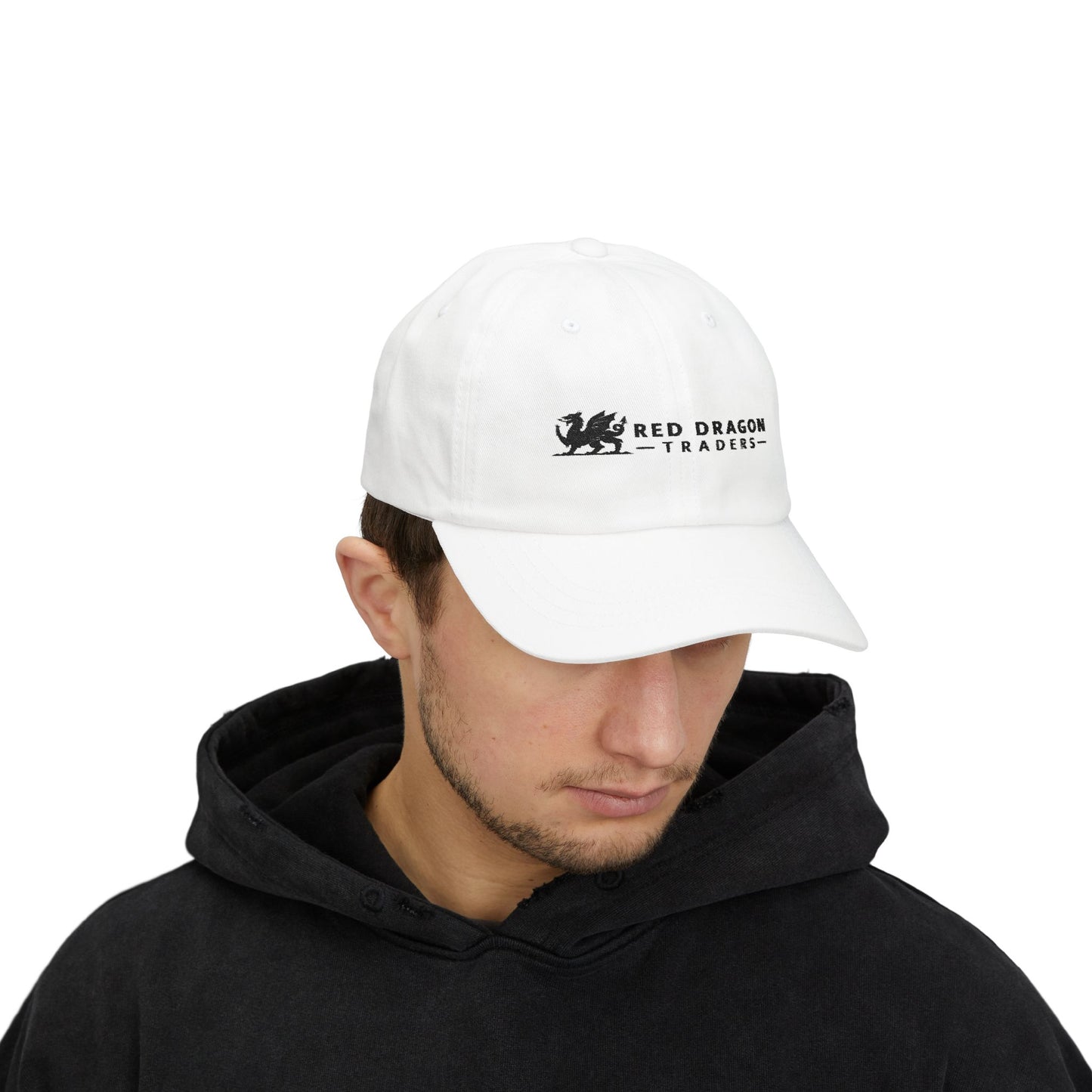 Person wearing a white cap with 'Red Dragon Traders' logo on a white background