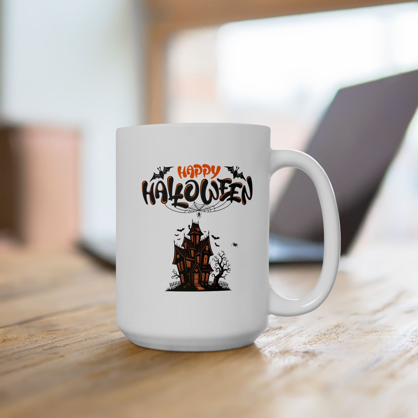White mug with Halloween design featuring a haunted house on a wooden surface.
