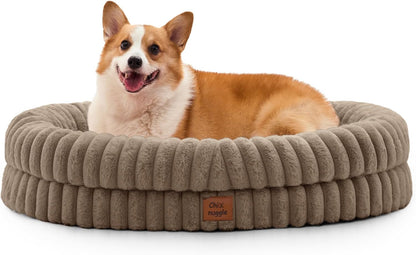 Dog lying on a beige pet bed with a visible brand label on a white background