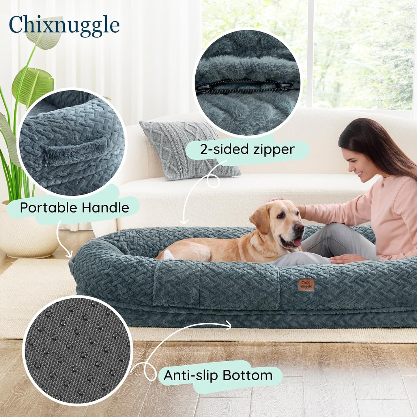 Dog bed with features highlighted, including a 2-sided zipper, portable handle, and anti-slip bottom, with a person petting a dog on a couch.