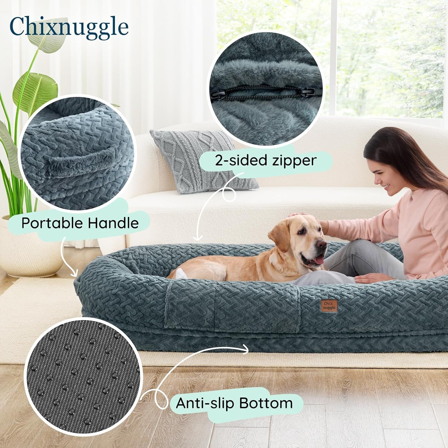 Dog bed with features highlighted, including a 2-sided zipper, portable handle, and anti-slip bottom, with a person petting a dog on a couch.