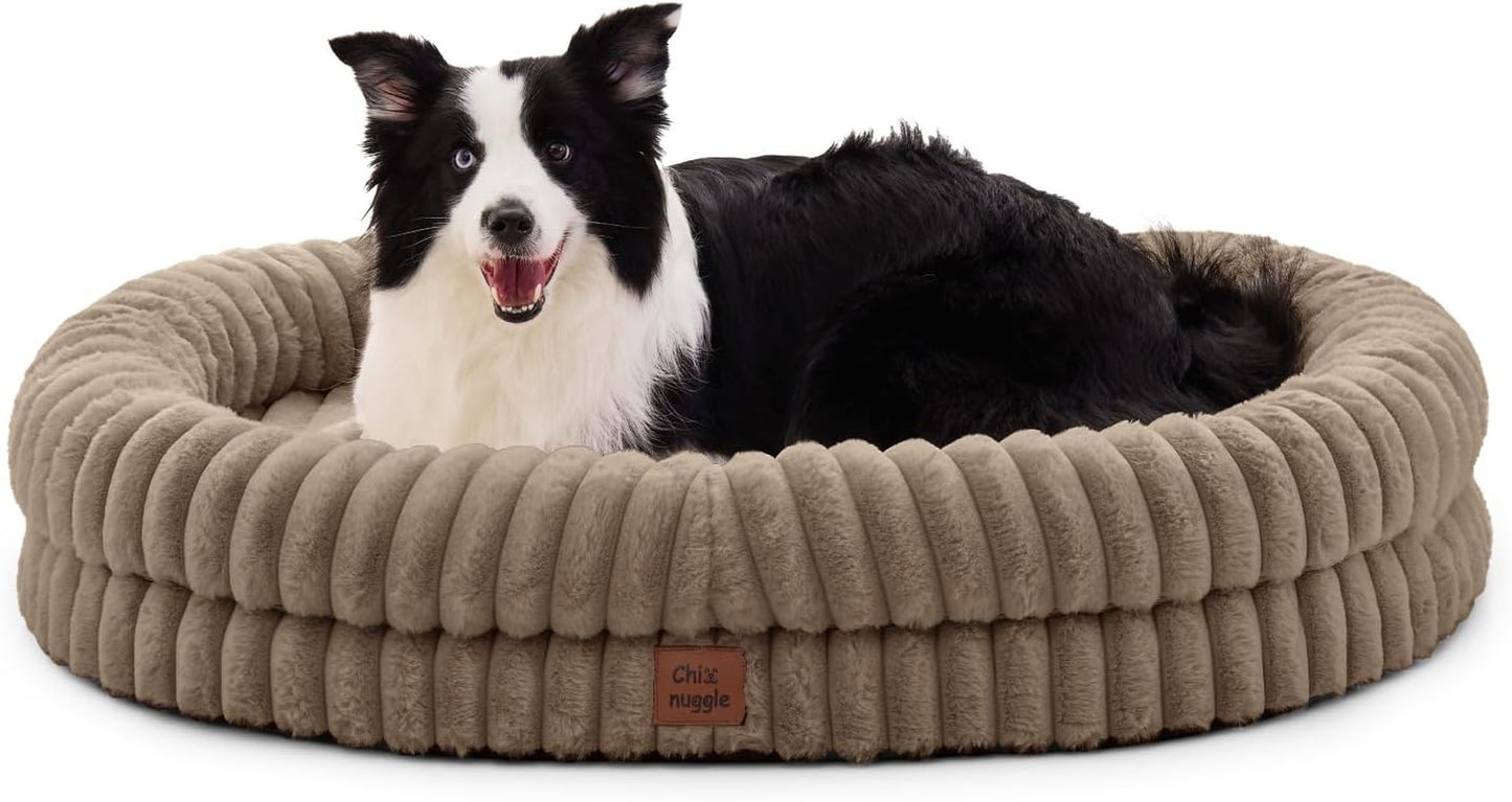 Dog lying on a beige pet bed with a visible brand logo.