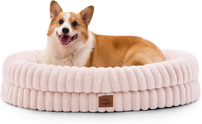 Dog lying on a fluffy pink pet bed with a visible brand label.