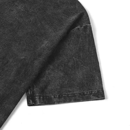 Close-up of a dark gray denim fabric with visible stitching on a white background