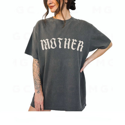 Person wearing a gray t-shirt with 'MOTHER' printed on it against a white background